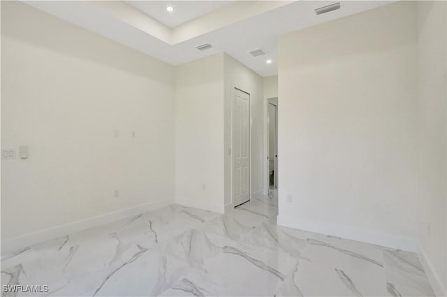 spare room featuring marble finish floor, baseboards, visible vents, and recessed lighting