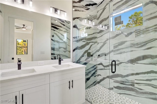 full bathroom featuring double vanity, a sink, and a marble finish shower