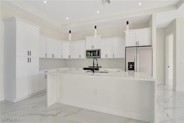 kitchen with a sink, visible vents, marble finish floor, appliances with stainless steel finishes, and a large island