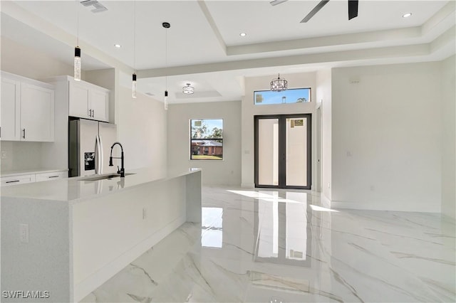 kitchen featuring a sink, visible vents, white cabinets, marble finish floor, and stainless steel refrigerator with ice dispenser