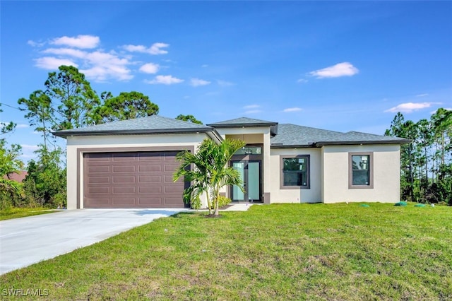 prairie-style home with an attached garage, stucco siding, driveway, and a front yard