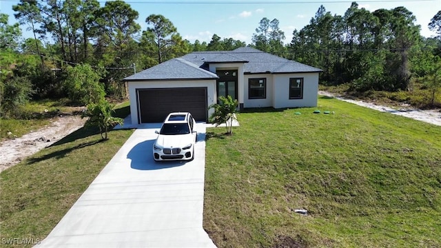 view of front of house featuring a garage, a front yard, driveway, and stucco siding