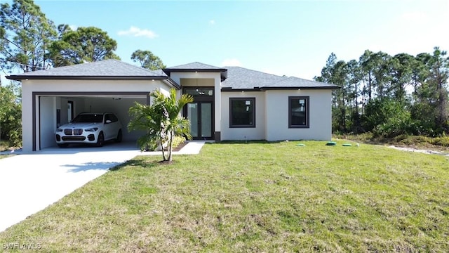 view of front of house featuring a garage, a front lawn, concrete driveway, and stucco siding