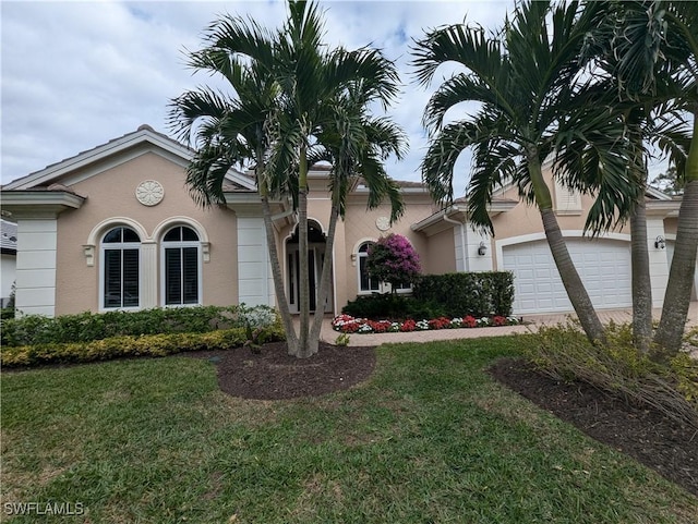 view of front of home with a front lawn and a garage