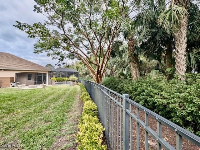 view of yard with glass enclosure