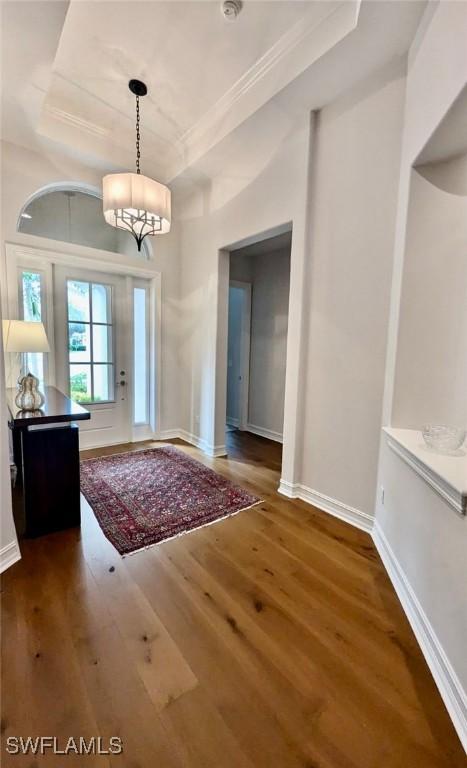 foyer featuring a notable chandelier and dark wood-type flooring