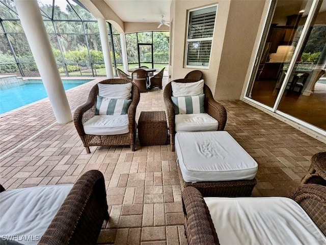 sunroom / solarium with ceiling fan and a pool