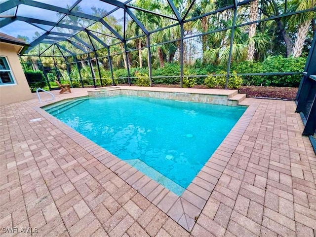 view of pool with a lanai and a patio