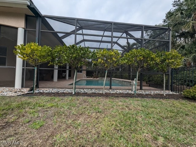 view of swimming pool with glass enclosure, a yard, and a patio area