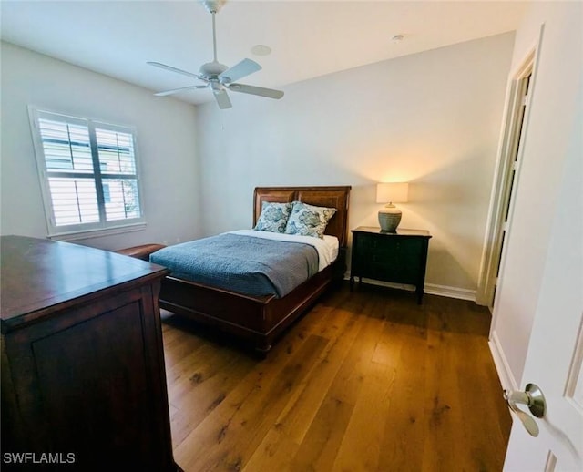 bedroom featuring ceiling fan and dark hardwood / wood-style flooring