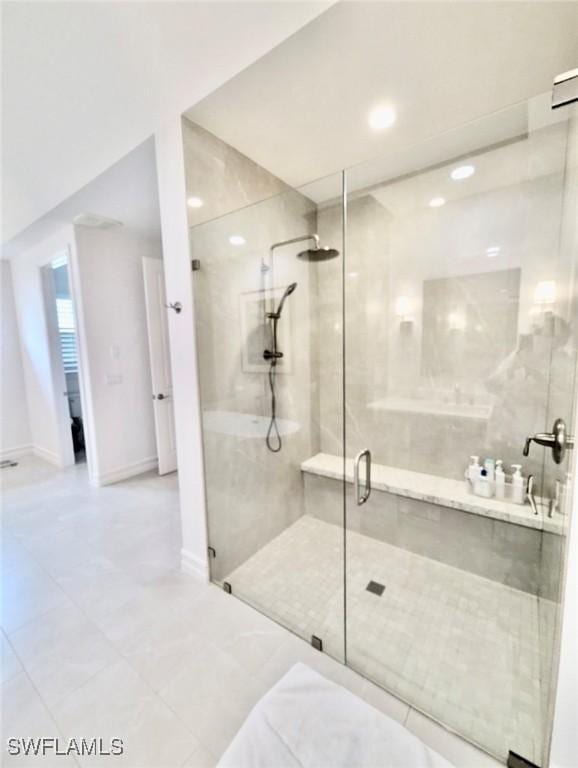 bathroom with a shower with door