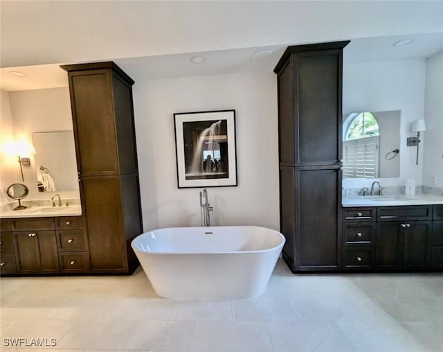 bathroom with a bath and vanity