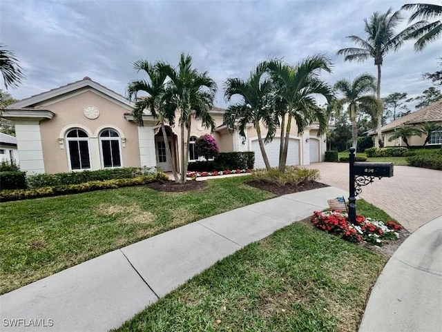 view of front facade featuring a garage and a front lawn