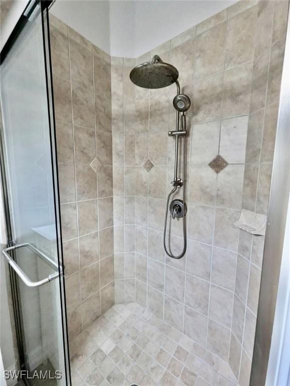 bathroom featuring a shower with door