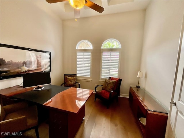 home office featuring ceiling fan and dark hardwood / wood-style flooring