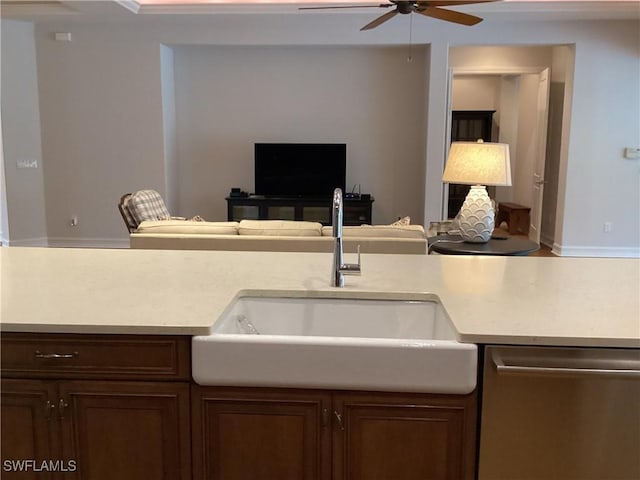 kitchen featuring ceiling fan, stainless steel dishwasher, and sink