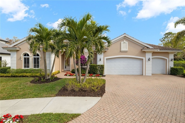 view of front of property with a garage and a front yard