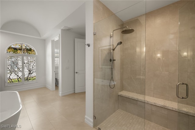 bathroom featuring separate shower and tub