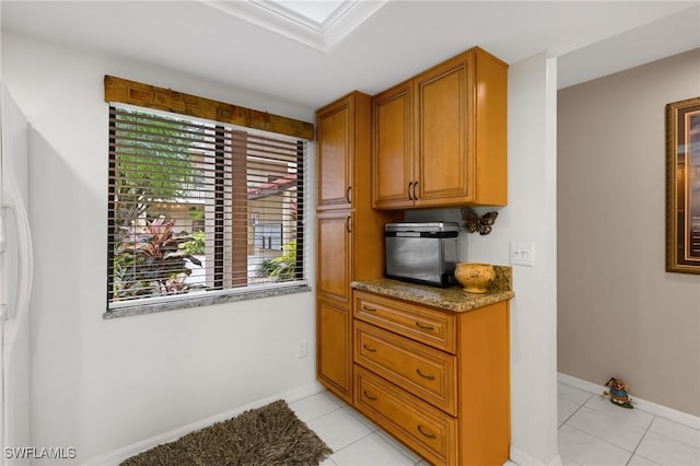 kitchen with light stone countertops and light tile patterned floors