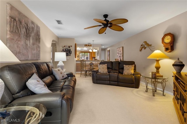 living room featuring carpet flooring and ceiling fan