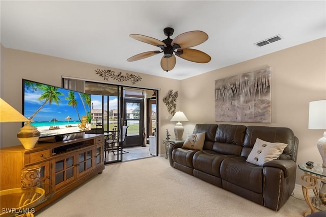 carpeted living room featuring ceiling fan