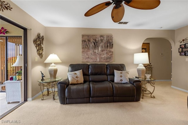 carpeted living room featuring ceiling fan