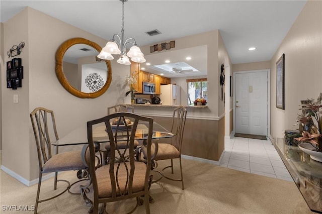 dining area with a notable chandelier and light tile patterned flooring