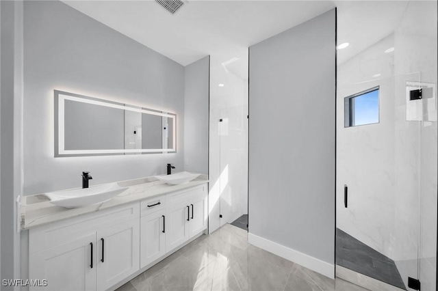 bathroom with vanity and a tile shower