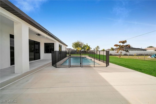 view of pool with a yard and a patio