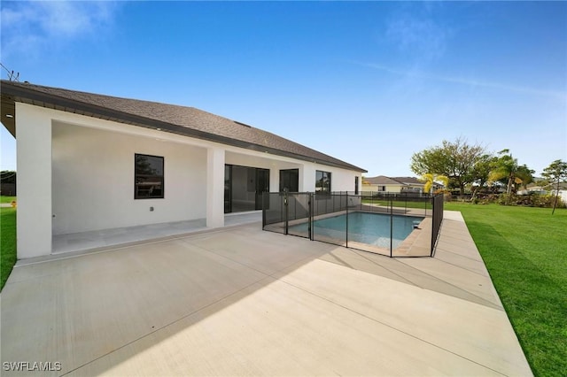 view of swimming pool with a patio area and a yard