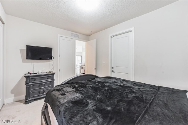 carpeted bedroom featuring a textured ceiling