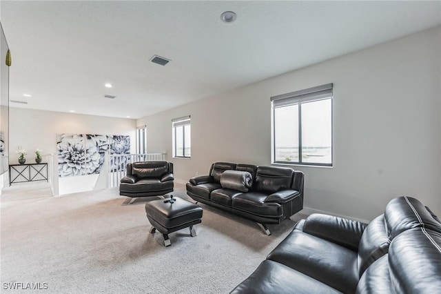 carpeted living room featuring plenty of natural light