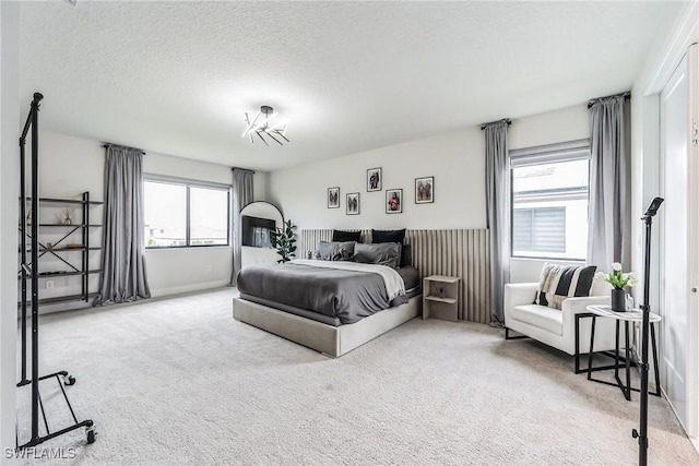 bedroom with carpet floors and a textured ceiling