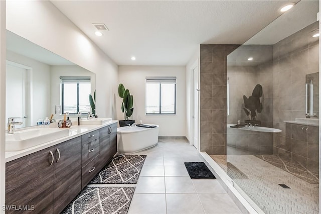 bathroom featuring tile patterned floors, separate shower and tub, and vanity