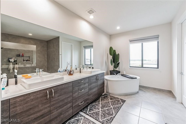 bathroom featuring vanity, tile patterned floors, and a bathing tub