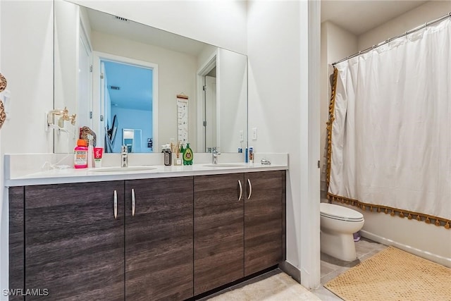 full bathroom with vanity, toilet, and shower / bath combo with shower curtain