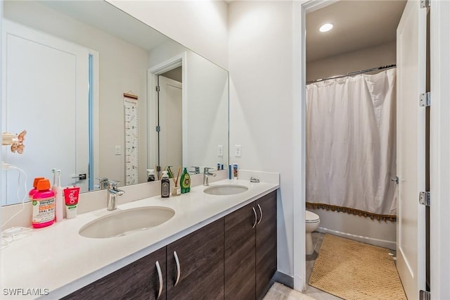 full bathroom featuring vanity, shower / bath combo, and toilet