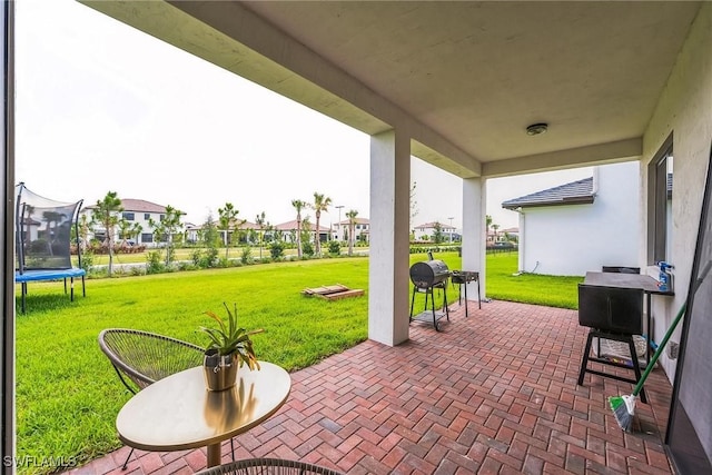 view of patio featuring a grill and a trampoline