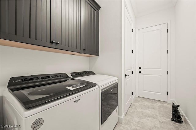 laundry area with cabinets and washing machine and clothes dryer