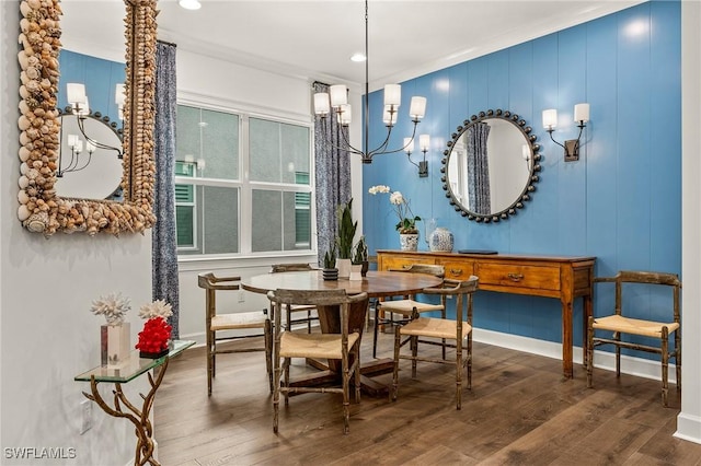 dining space featuring crown molding and hardwood / wood-style flooring