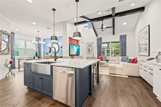 kitchen featuring dishwasher, hanging light fixtures, a kitchen island with sink, sink, and vaulted ceiling with beams