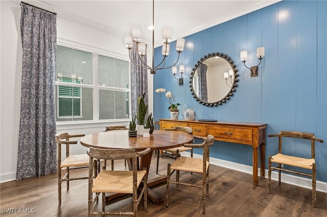 dining space featuring crown molding, hardwood / wood-style flooring, and an inviting chandelier