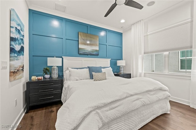 bedroom with ceiling fan, crown molding, and dark wood-type flooring