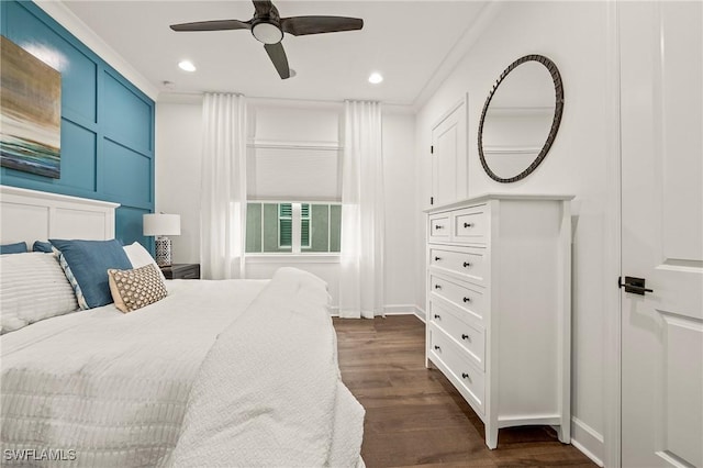 bedroom featuring ceiling fan, dark wood-type flooring, and ornamental molding