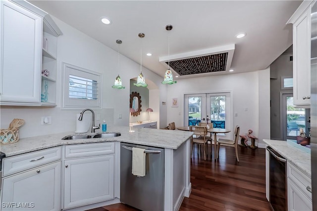 kitchen featuring french doors, sink, white cabinetry, stainless steel dishwasher, and kitchen peninsula