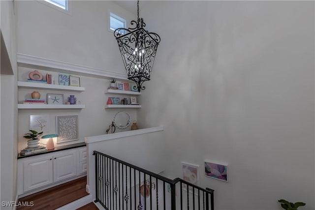 stairs with an inviting chandelier