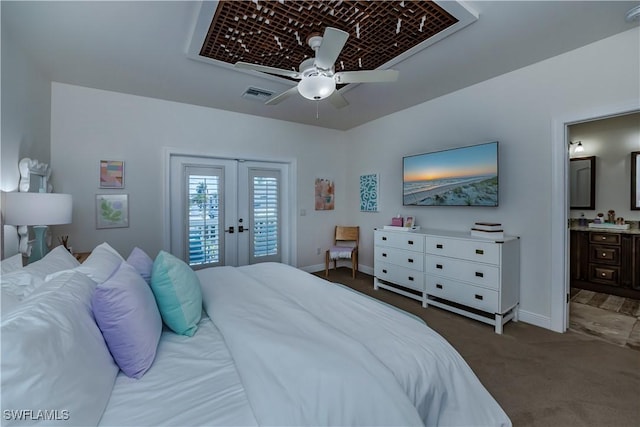 bedroom with ensuite bathroom, dark colored carpet, access to exterior, ceiling fan, and french doors