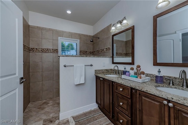 bathroom featuring vanity and a tile shower