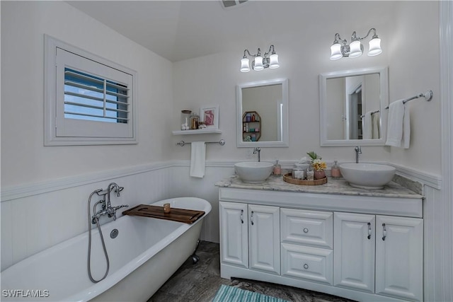 bathroom with vanity and a tub