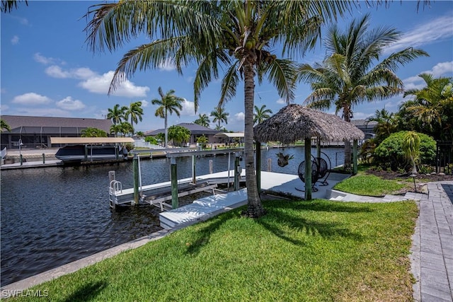 dock area with a water view and a lawn